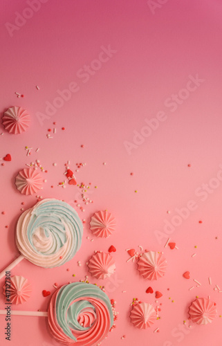  Pastel colored mint blue and pink Merengues and sweet candies on pink pastel background. Sweet candy concept. Copyspace. Happy Birthday greeting card.