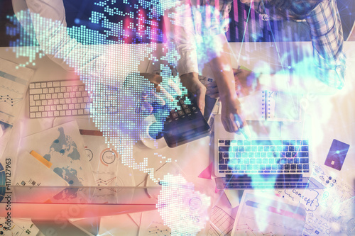 Double exposure of man and woman working together and financial graph hologram drawing. market analysis concept. Computer background. Top View.