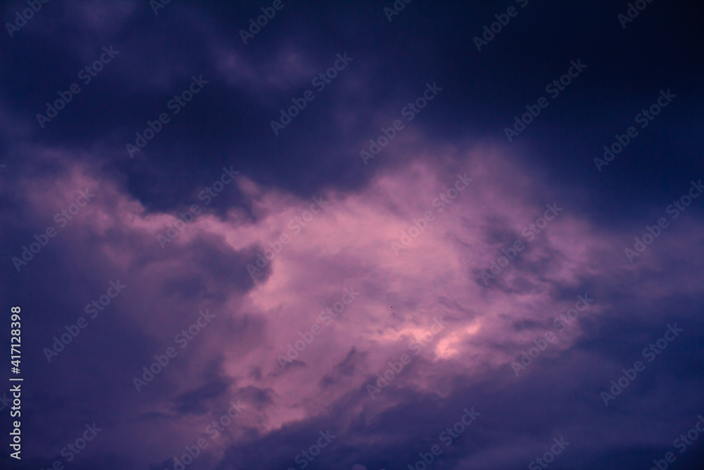 Striking fluffy clouds in the blue sky. Background for designers.