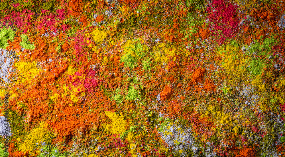 Holi festival celebration. Traditional Indian Holi colours powder decoration on black background for Holi festival. Holi festival celebration. Traditional Indian Holi colours powder decoration on black background for Holi festival.