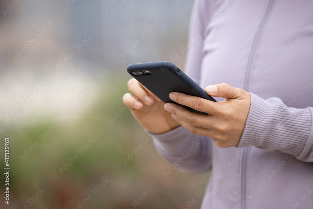 Asian woman using smartphone outdoors Asian woman using smartphone outdoors