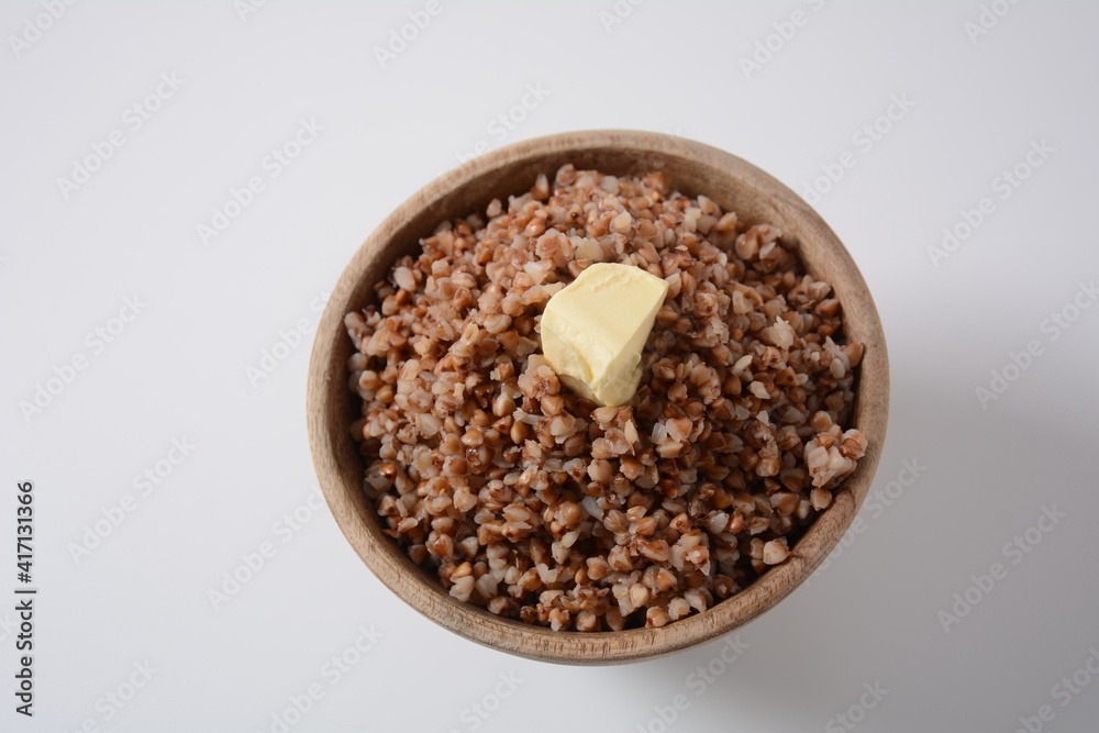 Bowl of tasty buckwheat porridge with piece of butter on the top Bowl of tasty buckwheat porridge with piece of butter on the top
