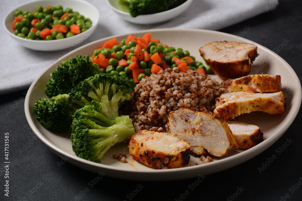 Healthy breakfast. Tasty buckwheat porridge, grilled chicken fillet and vegetables boiled Healthy breakfast. Tasty buckwheat porridge, grilled chicken fillet and vegetables boiled