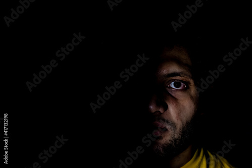 Portrait of middle eastern guy in a dark room