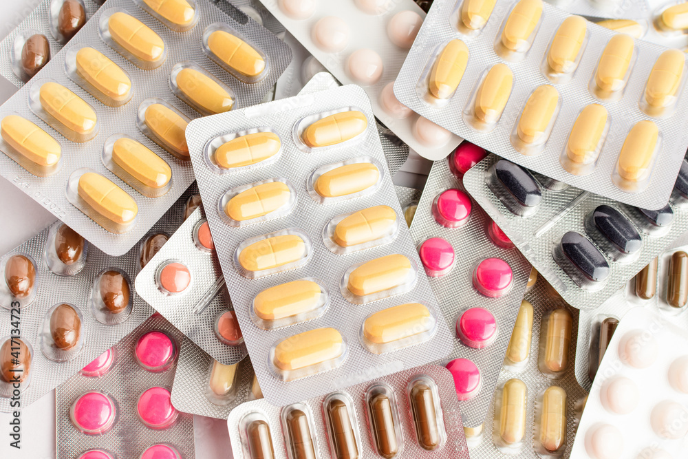 Close up of different medicine pills, tablets and vitamins isolated on white background, pharmaceutical picture taken with soft focus. Close up of different medicine pills, tablets and vitamins isolated on white background, pharmaceutical picture taken with soft focus.