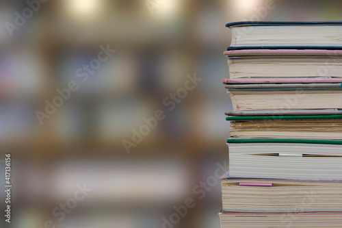 Stacking books in library room, bookshelf with blurred work and education background, back to school concept