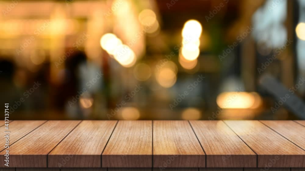 Empty wooden table top with lights bokeh on blur restaurant background.
