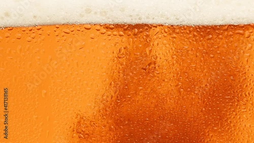 Close up background of beer with bubbles in glass