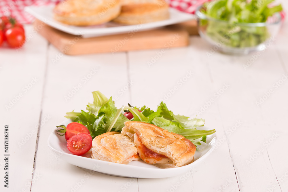 Puff pastry filled with tomato and mozzarella cheese. Puff pastry filled with tomato and mozzarella cheese.