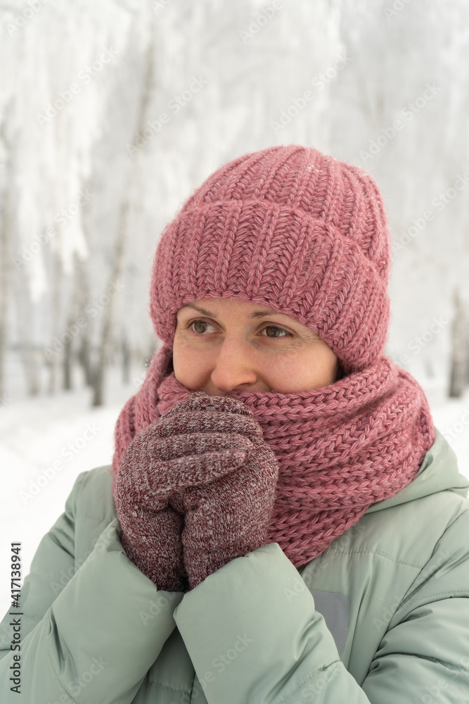 Portrait of a girl in a red hat and gloves in a winter park Portrait of a girl in a red hat and gloves in a winter park