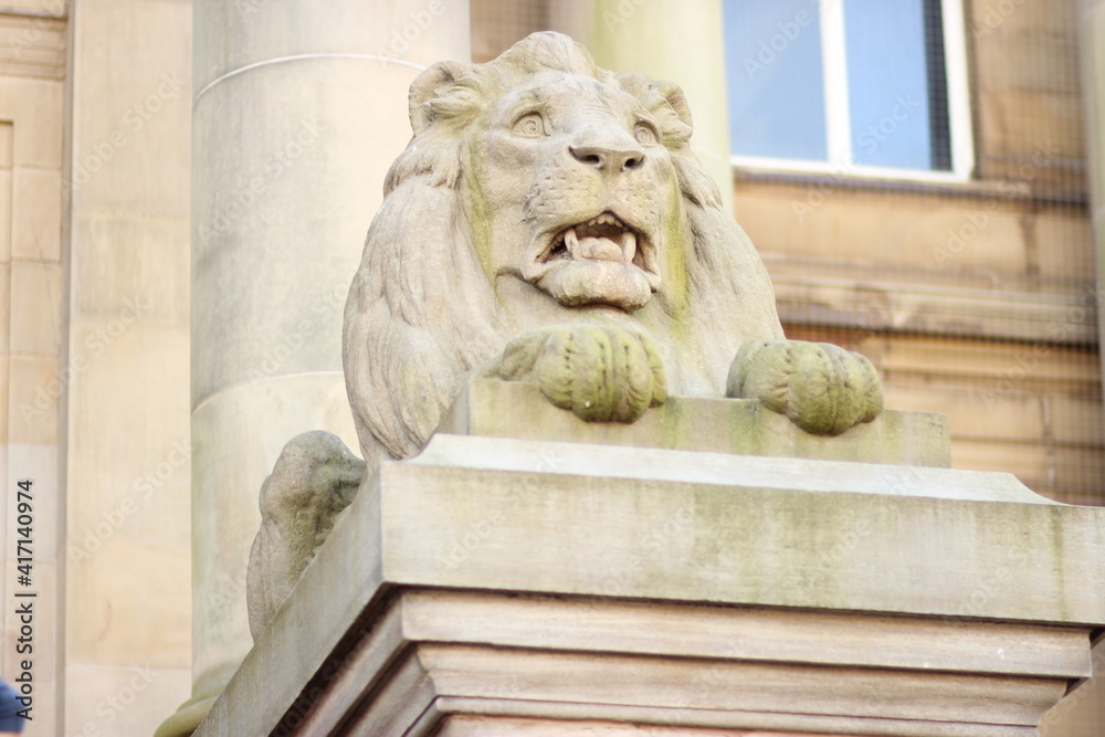 Stone lion statue in front of Bolton town hall