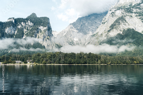 Reflecting mountains, a forest and fog in the water of the Koenigssee (Königssee) in the Berchtesgadener Land, Bavaria, Germany