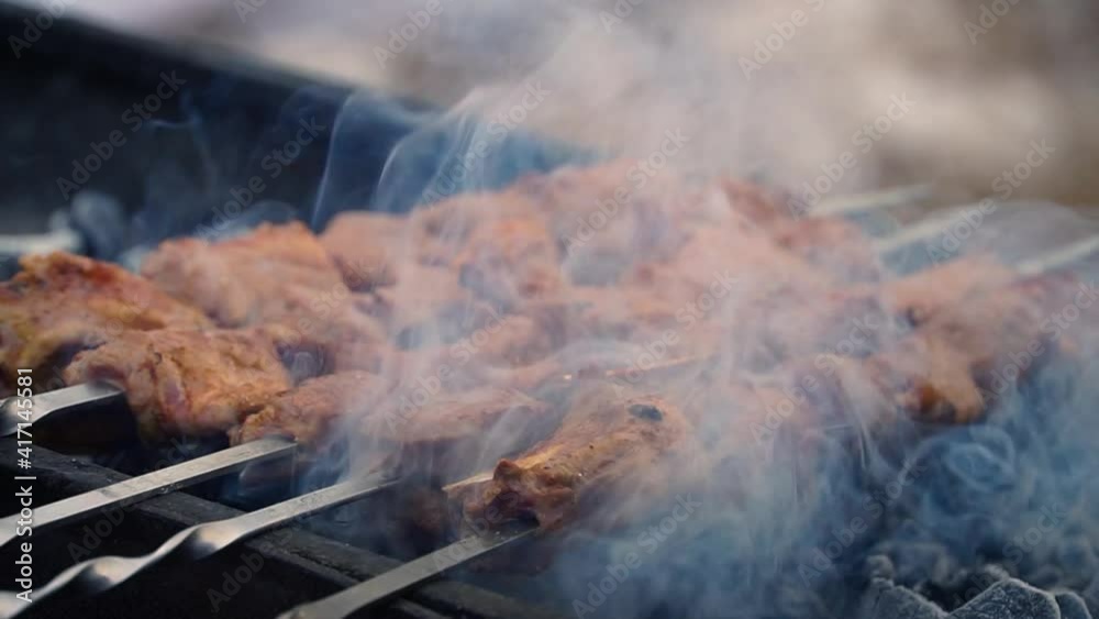 chicken seekh kebab on griller.Grillng roasting seekh kebab on barbecue griller. Preparing and cooking fiery smokey kebabs.Famous seekh kebab of delhi india.Meat seekh kebab chicken seekh kebab on griller.Grillng roasting seekh kebab on barbecue griller. Preparing and cooking fiery smokey kebabs.Famous seekh kebab of delhi india.Meat seekh kebab