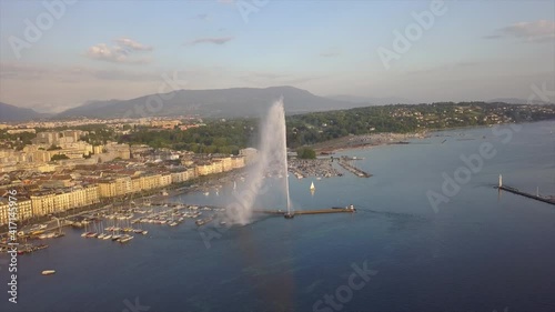 sunset light geneva cityscape lake famous fountain bay aerial panorama 4k switzerland