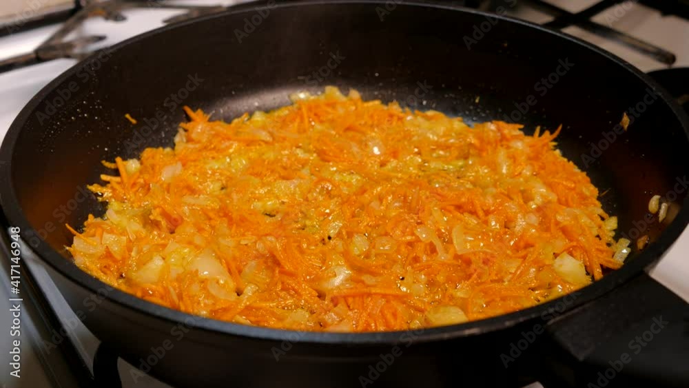  Red dish boils in a pan.  Stew with vegetables and table beets and carrots.