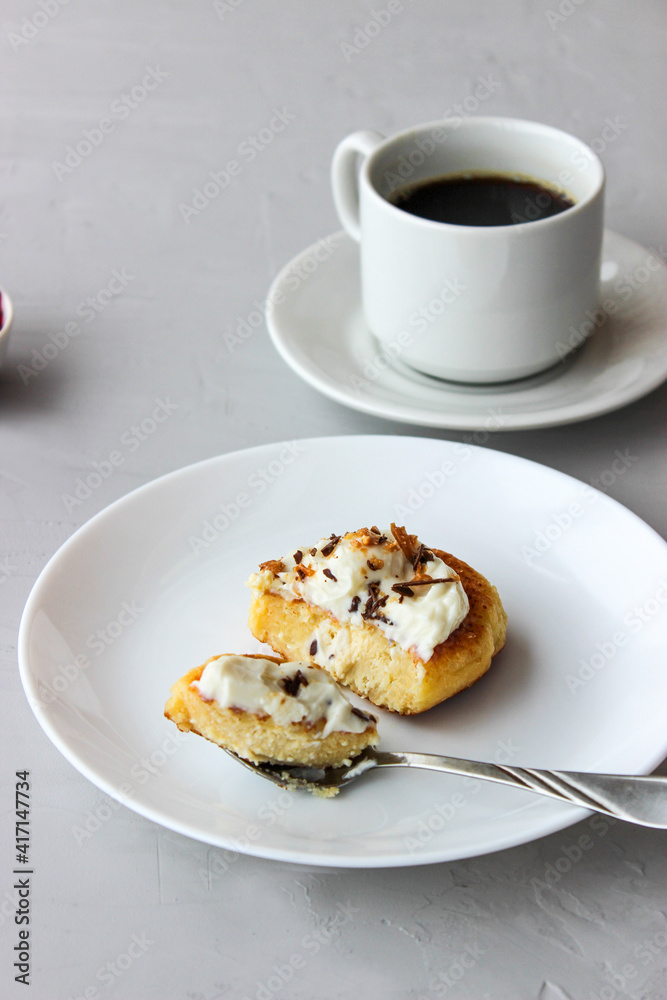 Breakfast of cheesecakes on a plate with sour cream. Breakfast of cheesecakes on a plate with sour cream.