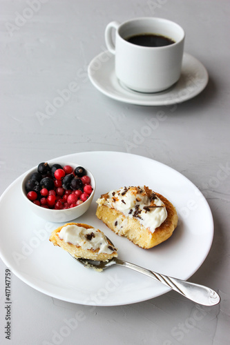 Breakfast of cheesecakes on a plate with sour cream.