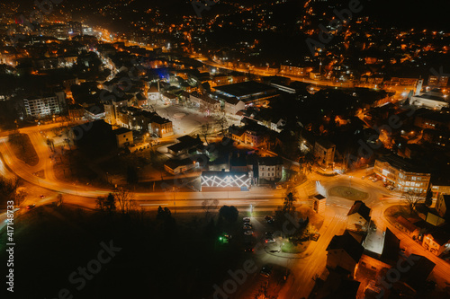 Fototapeta Naklejka Na Ścianę i Meble -  Aerial view of downtown Tuzla at night, Bosnia. City photographed by drone, traffic and objects , landscape