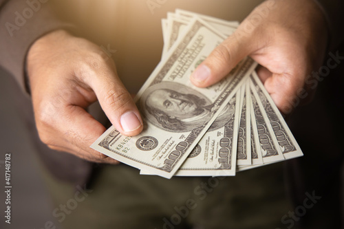 Close up male hand Counting money us dollar. Financial business concept.