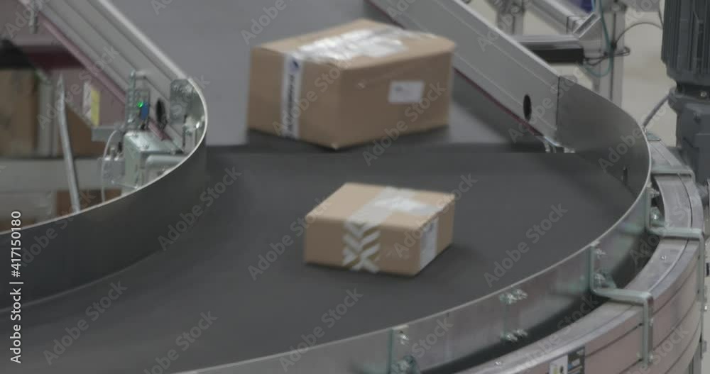 Boxes Parcels Packages at Fast Conveyer in Distribution Warehouse