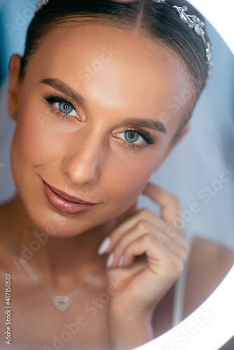 Portrait of stunning bride with wedding makeup and hairstyle