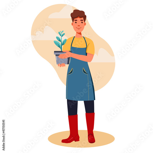 A man Of Gardener. Man holding flowers, flower pot and plant.Spring Gardening.  Young Farmer engaged in gardening. 