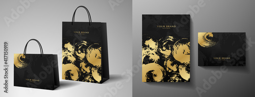 Luxury shopping paper bag design. Template with gold and black print. Luxe abstract blot (brush stroke) pattern for brand gift packet, premium shop purchase. Vector modern layout