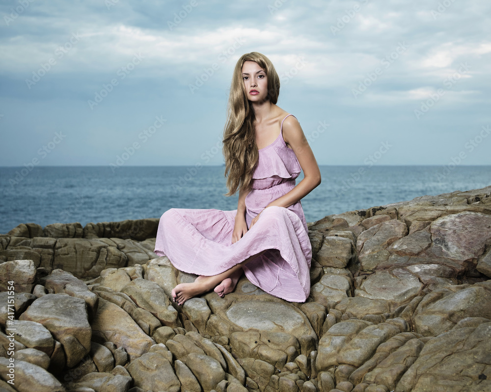Beautiful blonde woman on the beach. Lady in pink dress Beautiful blonde woman on the beach. Lady in pink dress