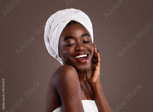 Portrait of African woman with head towel touching face