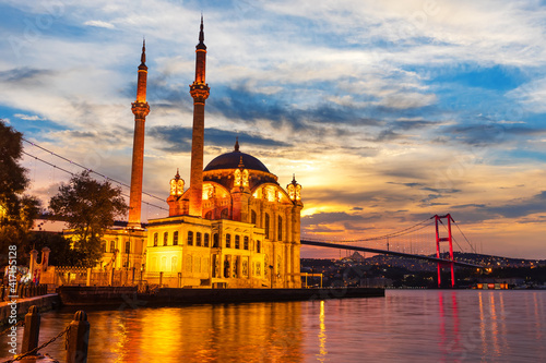 A Grand Imperial Mosque of Istanbul and the Bosphorus bridge in the night lights