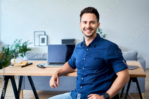 Portrait of confident young business man working at home