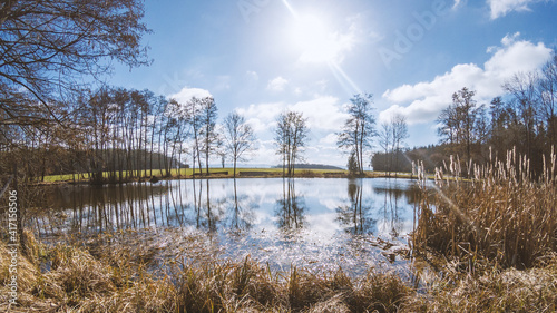 Sunny day on a small pond in winter