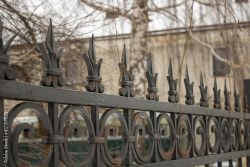 Beautiful decorative vintage wrought iron fence with artistic forging. Metal fencing close up.