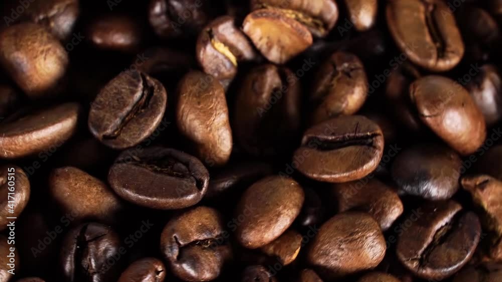 Rotating and falling. Coffee beans. Close up of seeds of coffee. Beautiful seeds of coffee. Fragrant coffee beans scrolls slowly around the camera. Rotating and falling. Coffee beans. Close up of seeds of coffee. Beautiful seeds of coffee. Fragrant coffee beans scrolls slowly around the camera.