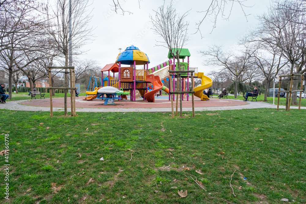 Bayrampasa, Istanbul, Turkey - 02.17.2021: Topkapi public park with slides and playground in a cloudy day and no kids with copy space Bayrampasa, Istanbul, Turkey - 02.17.2021: Topkapi public park with slides and playground in a cloudy day and no kids with copy space