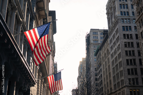 American Flags Hanging Outside a Building along a Street in the Flatiron District of New York City with a Bright Sun