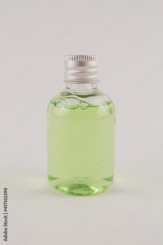 light green shampoo in a transparent bottle on a white background light green shampoo in a transparent bottle on a white background