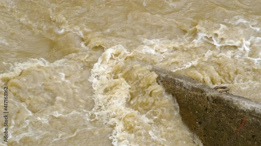 Dirty water of muddy river in flooding period during heavy rains in spring. Dirty water of muddy river in flooding period during heavy rains in spring.