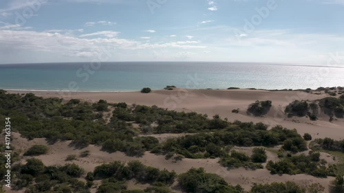 Dunes of Baní carribean desert aerial cinematic view of travel destination in Dominican republic . blue ocean, overlooking the coast of Mangla, sunny day, in Sabana Buey photo