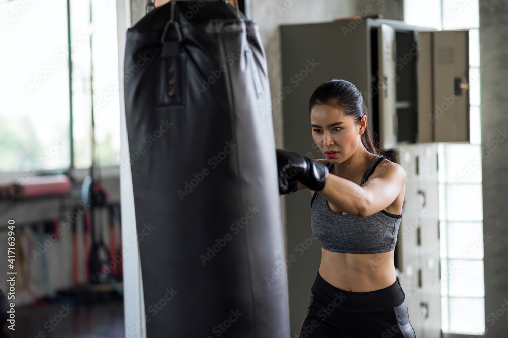Asian woman boxing training in fitness gym
