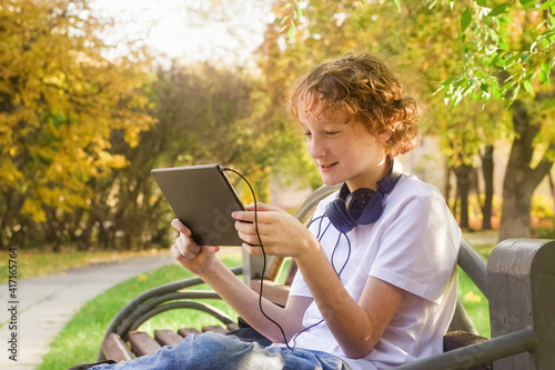 Teenage boy with a gadget outdoors