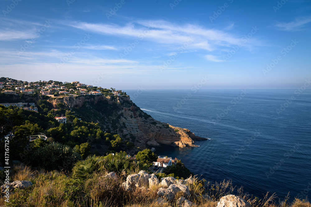 Residential area on top of a cliff on the coast of Javea on a summer day with blue sky, Javea, Alicante, Spain
