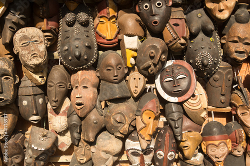 Traditional african masks hanging for sell in a market stall