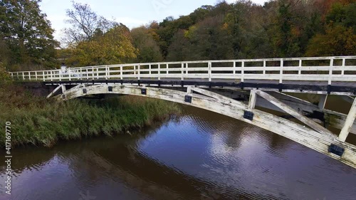 Wooden bridge near Ditton Locks Near Northwich Cheshire on the river Weaver photo