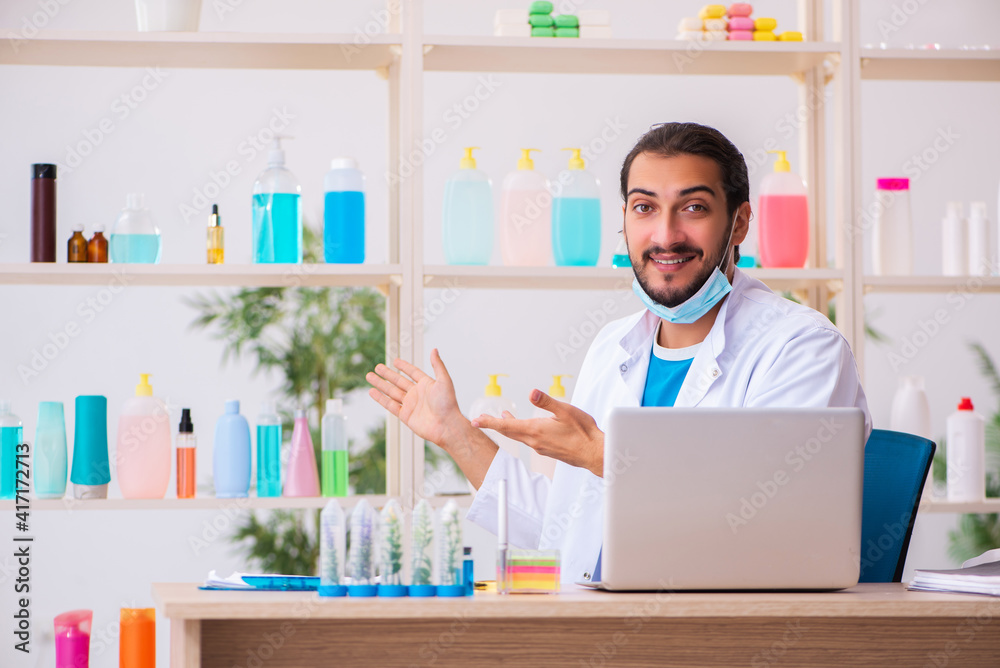 Young male chemist testing soap in the lab Young male chemist testing soap in the lab