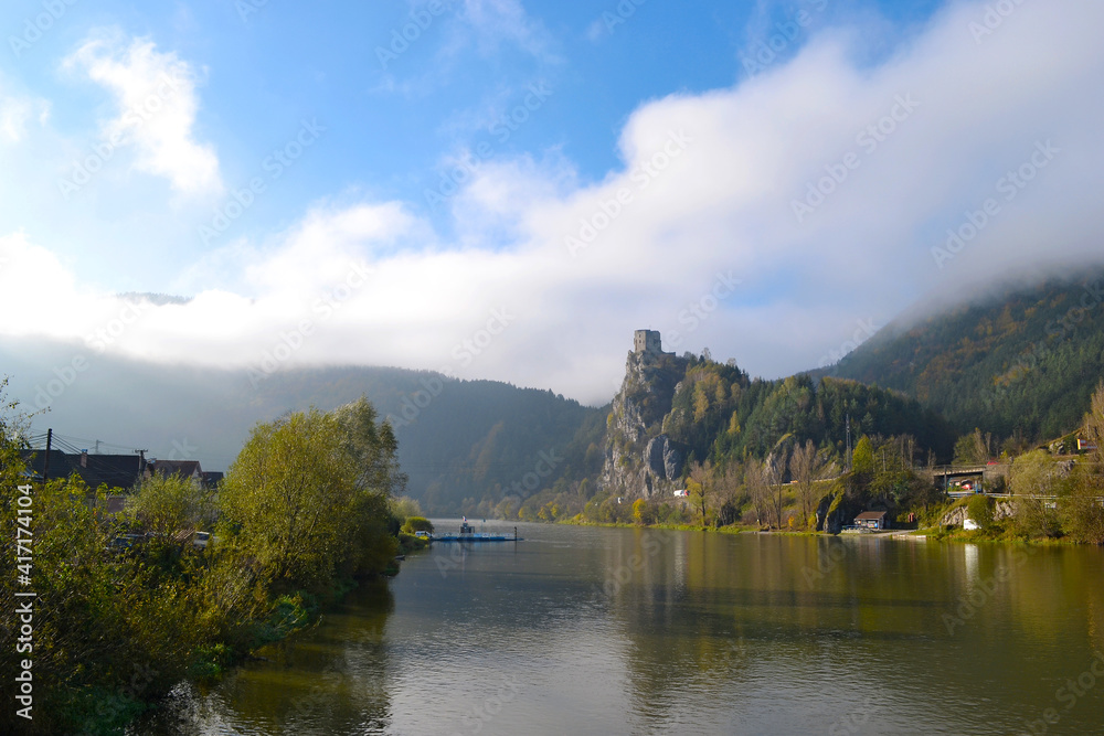 The ruins of the historic castle Strecno in Slovakia. Castle on a rock above the river in a foggy morning. Europe.