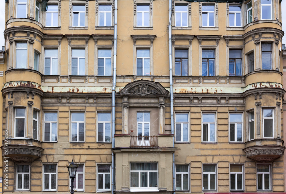 Vintage architecture classical yellow building facade before renovation