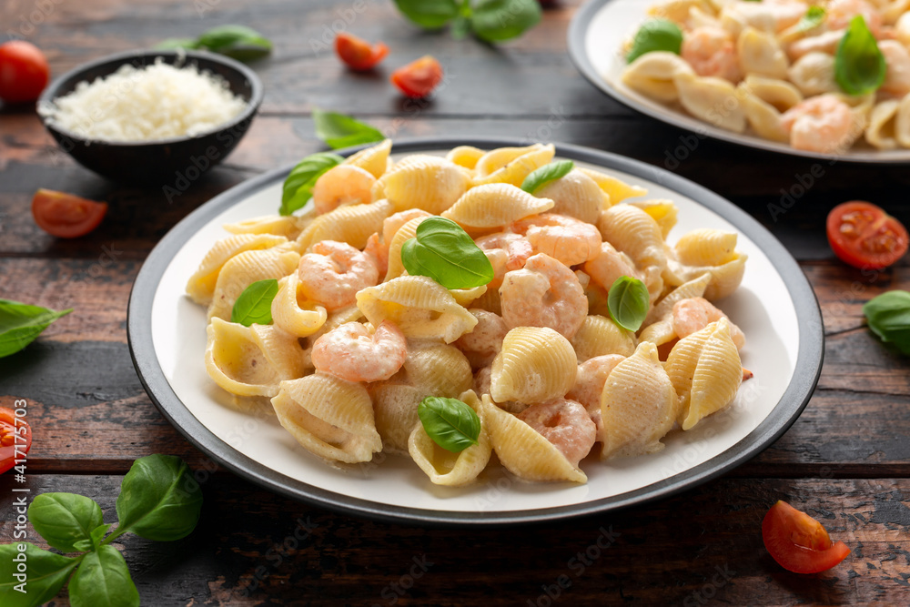 Italian conchiglie prawn, shrimp pasta in a creamy sauce on plate.