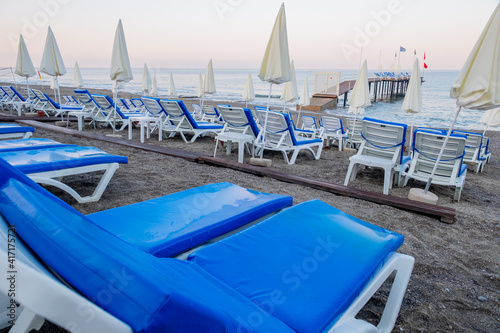 Chairs on the sandy beach near the sea