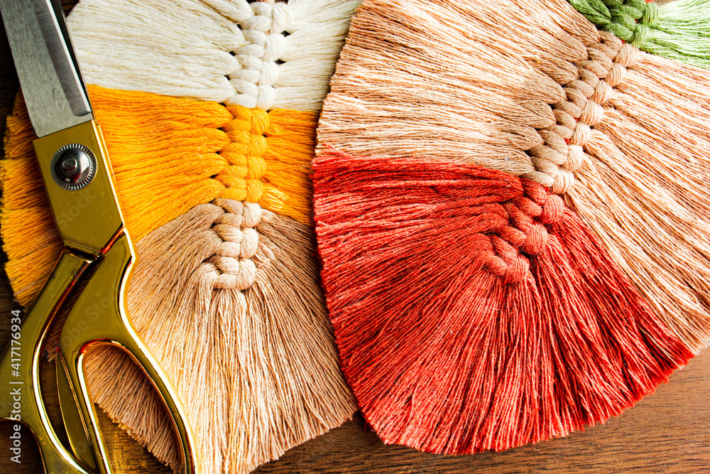 Obraz na plátně Colorful leaf motif from macrame threads and scissors